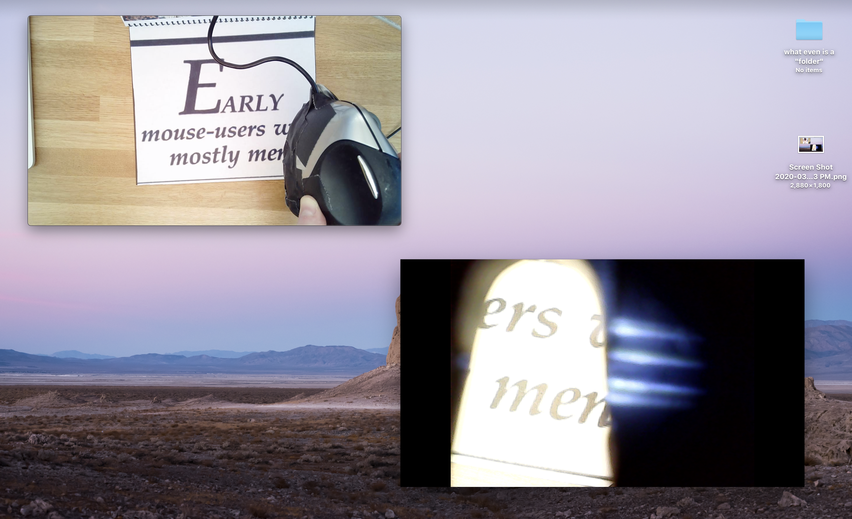 Screenshot of desktop. One video feed of vertical mouse housing an endosopic camera hovering over a mouse pad that is also a book. One video feed from endoscopic camera, in this case a part of a quote that reads: early mouse users were mostly men